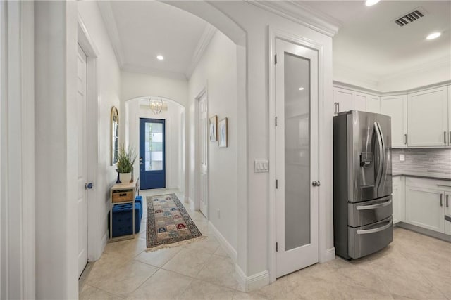 interior space with a chandelier and crown molding