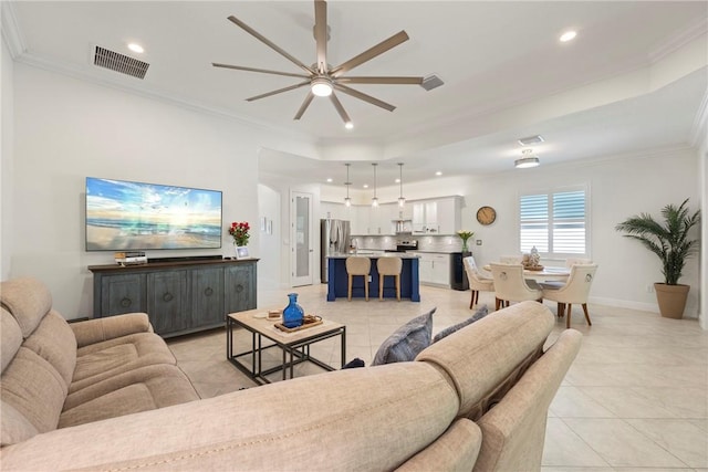 living room with ceiling fan, light tile patterned flooring, and ornamental molding