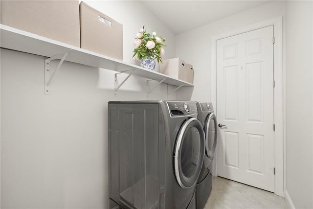 washroom with washer and clothes dryer and light tile patterned floors