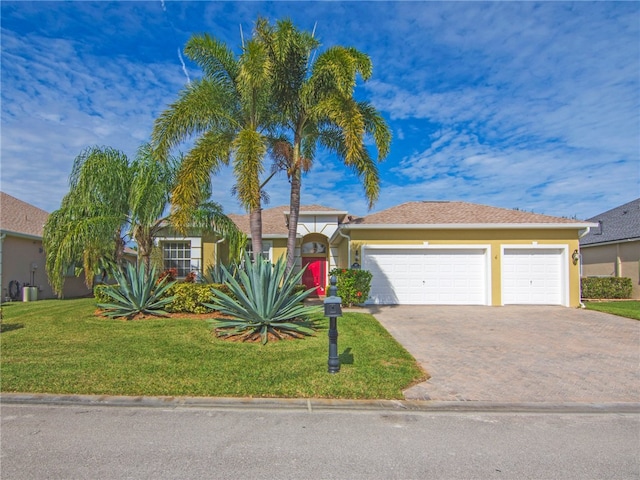 ranch-style home with a garage and a front yard