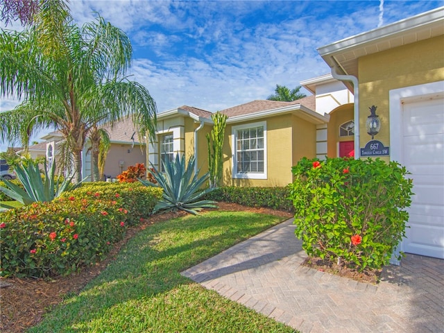 exterior space featuring a lawn and a garage