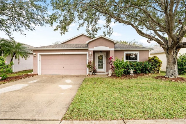 ranch-style home with a garage and a front yard