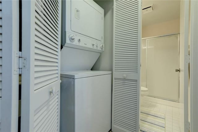5760 Marina Dr Unit 4, Sebastian, FL 32958 - laundry area featuring stacked washer and clothes dryer and tile patterned flooring