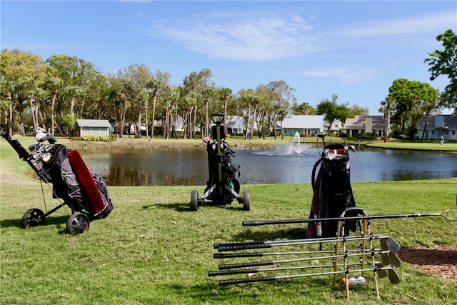 view of property's community with a yard and a water view