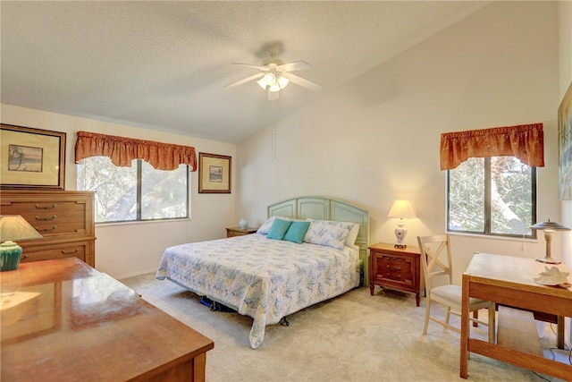 carpeted bedroom with ceiling fan, a textured ceiling, and vaulted ceiling