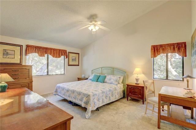 5760 Marina Dr Unit 4, Sebastian, FL 32958 - bedroom with light colored carpet, a textured ceiling, a ceiling fan, and high vaulted ceiling