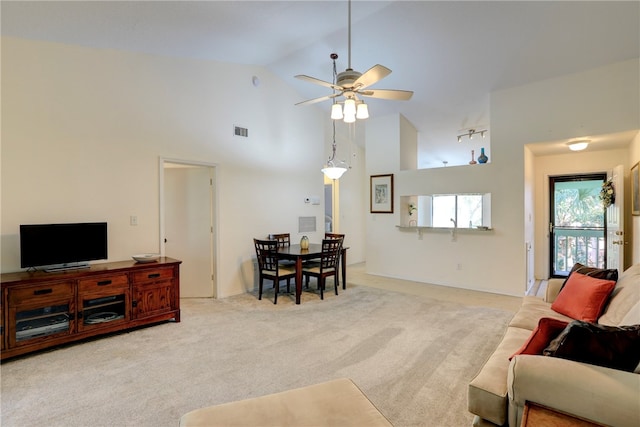 carpeted living room featuring ceiling fan and high vaulted ceiling