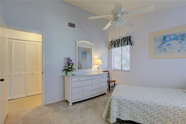 bedroom featuring ceiling fan, lofted ceiling, light carpet, and a closet