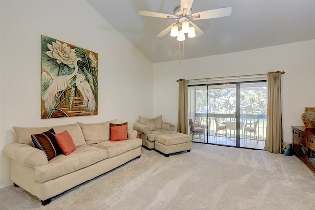 carpeted living room with ceiling fan and vaulted ceiling