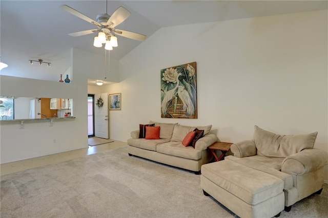 carpeted living room featuring ceiling fan, high vaulted ceiling, and track lighting