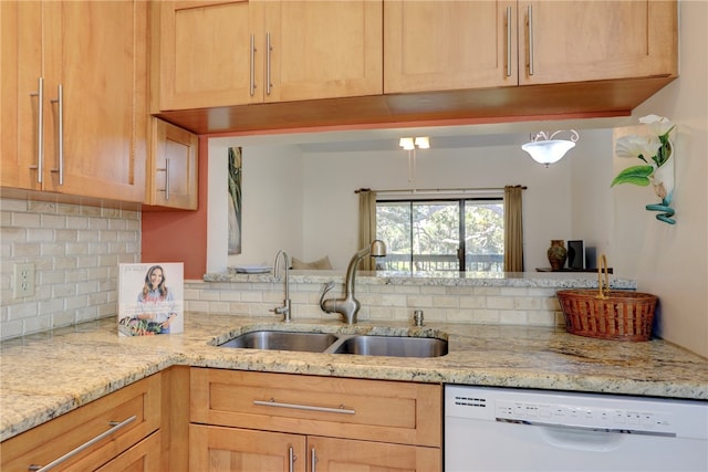 kitchen featuring dishwasher, light brown cabinets, backsplash, and sink