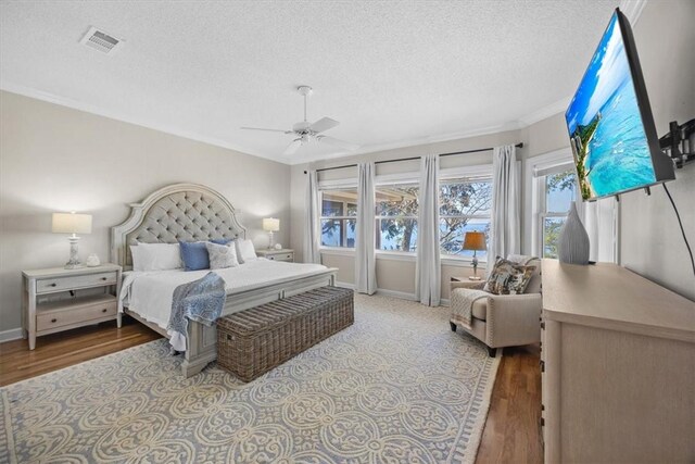 449 S Garcon Point Rd Fl, Milton, FL 32583 - bedroom featuring a textured ceiling, wood finished floors, crown molding, and a ceiling fan