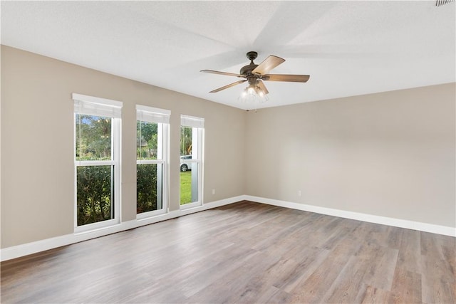 empty room featuring ceiling fan and light hardwood / wood-style floors