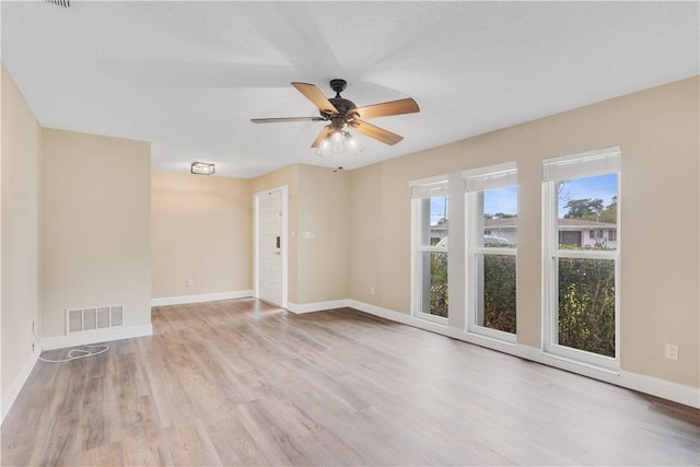 unfurnished room with ceiling fan and light hardwood / wood-style flooring