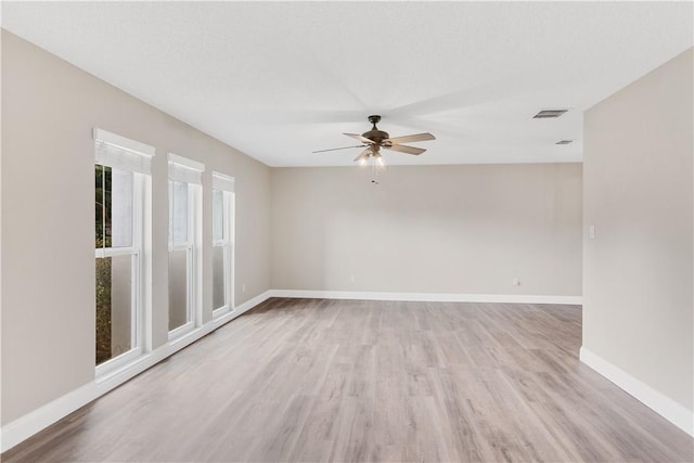 spare room with light wood-type flooring and ceiling fan