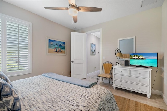 bedroom featuring light wood-type flooring, baseboards, and ceiling fan