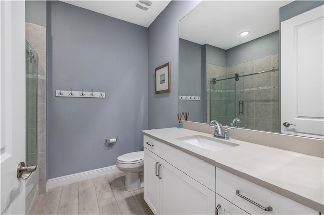 bathroom with visible vents, baseboards, toilet, a stall shower, and vanity