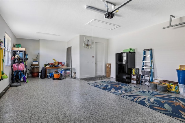 garage with baseboards, a garage door opener, and freestanding refrigerator