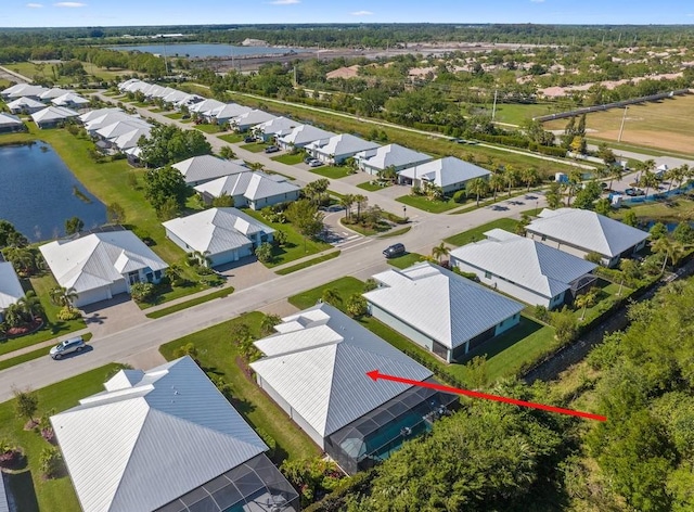 birds eye view of property with a water view and a residential view