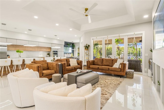 living area featuring a ceiling fan, recessed lighting, marble finish floor, and french doors