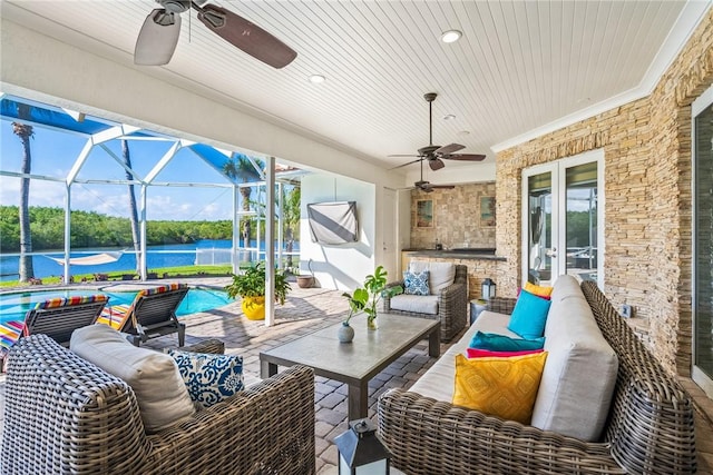 view of patio / terrace with glass enclosure, an outdoor pool, french doors, a water view, and outdoor lounge area