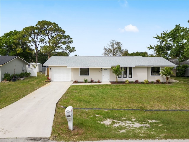 ranch-style home featuring a garage, driveway, a front lawn, and fence