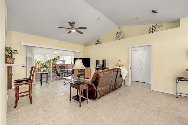 living room with ceiling fan, light tile patterned floors, and vaulted ceiling