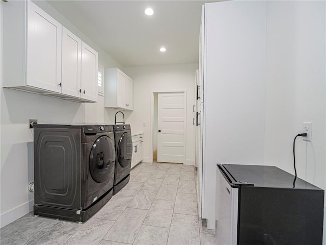 washroom featuring cabinets and independent washer and dryer