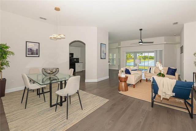 590 Valencia Cir SW, Vero Beach, FL 32968 - dining space with arched walkways, wood finished floors, ceiling fan, and baseboards
