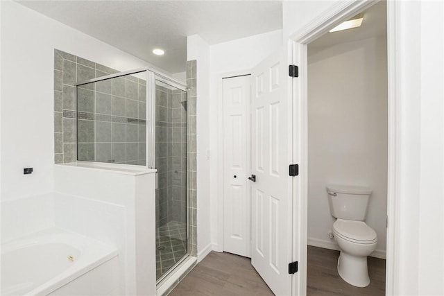 590 Valencia Cir SW, Vero Beach, FL 32968 - full bathroom featuring a shower stall, wood finished floors, a bath, toilet, and recessed lighting