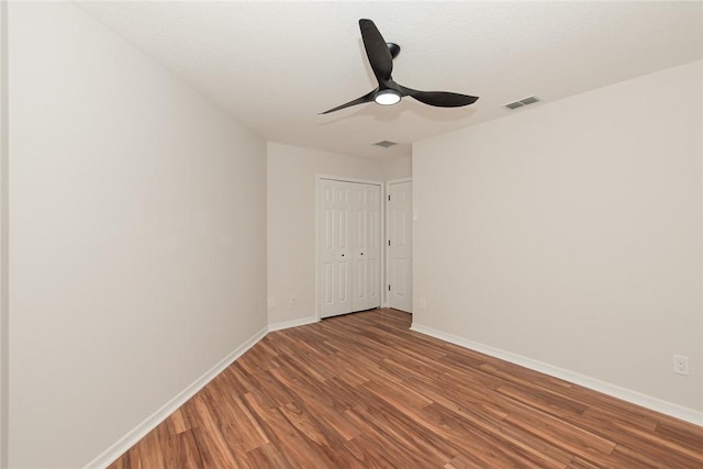 590 Valencia Cir SW, Vero Beach, FL 32968 - empty room with wood finished floors, baseboards, and ceiling fan