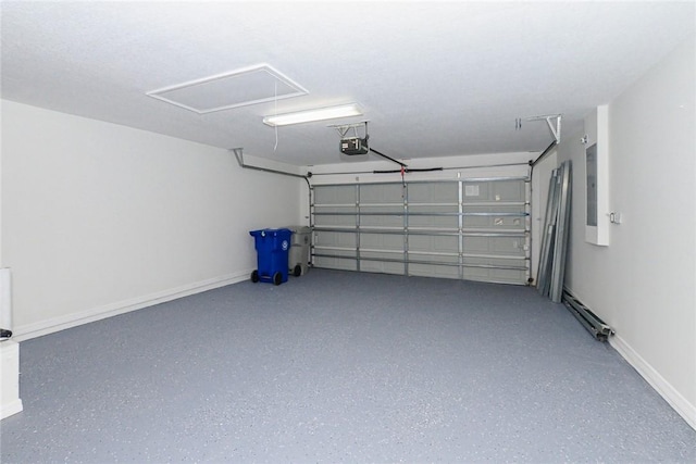 590 Valencia Cir SW, Vero Beach, FL 32968 - garage with a garage door opener, electric panel, and baseboards
