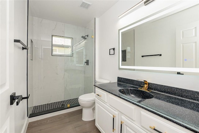 590 Valencia Cir SW, Vero Beach, FL 32968 - full bath with toilet, a marble finish shower, vanity, and wood finished floors