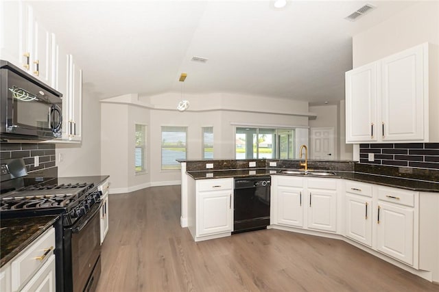 590 Valencia Cir SW, Vero Beach, FL 32968 - kitchen featuring black appliances, a sink, a peninsula, light wood-style floors, and white cabinetry