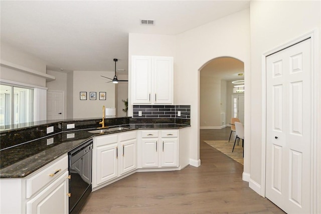 590 Valencia Cir SW, Vero Beach, FL 32968 - kitchen featuring dishwasher, a sink, a ceiling fan, arched walkways, and decorative backsplash