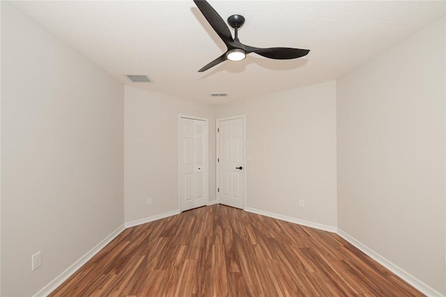 590 Valencia Cir SW, Vero Beach, FL 32968 - spare room with wood finished floors, baseboards, and a ceiling fan