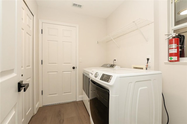 590 Valencia Cir SW, Vero Beach, FL 32968 - laundry room with separate washer and dryer and dark wood-type flooring