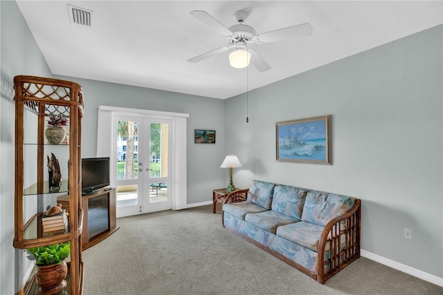 living room with french doors, ceiling fan, and carpet