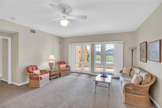 carpeted living room featuring ceiling fan