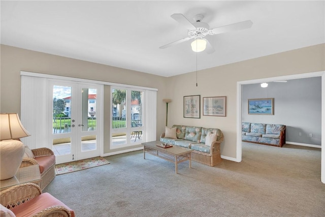 carpeted living room featuring ceiling fan and french doors