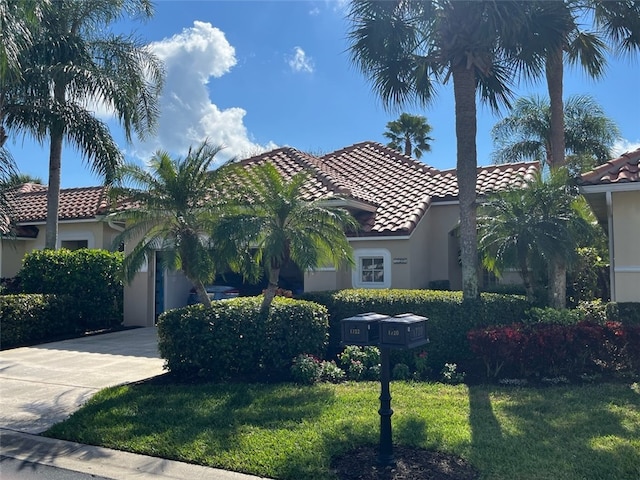 mediterranean / spanish-style house with a front lawn