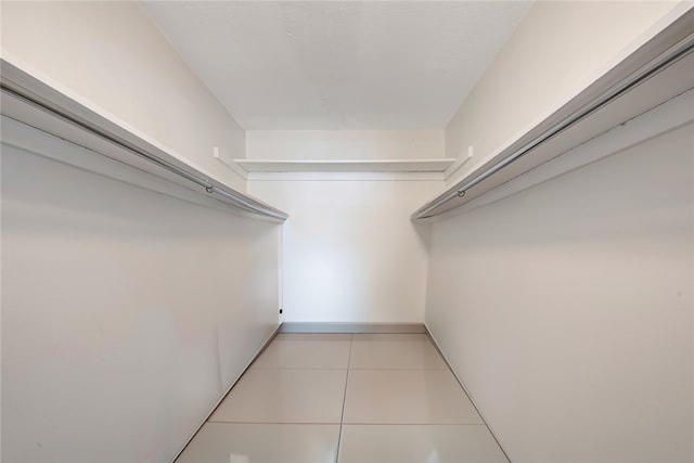 walk in closet with light tile patterned floors