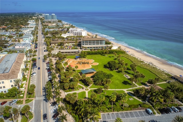 drone / aerial view featuring a water view and a view of the beach