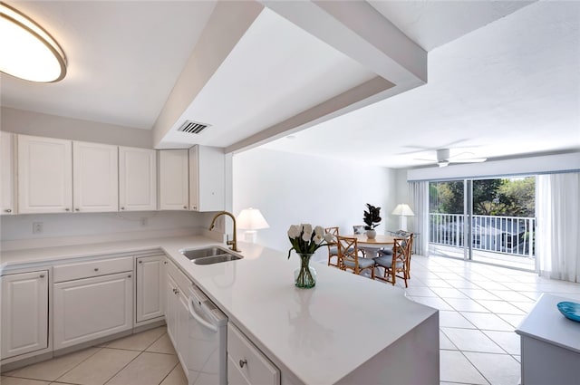 kitchen featuring white cabinetry, dishwasher, light tile patterned floors, and sink