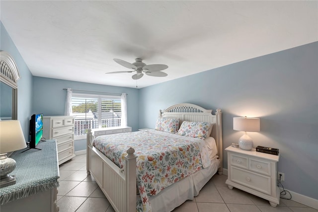 tiled bedroom featuring ceiling fan