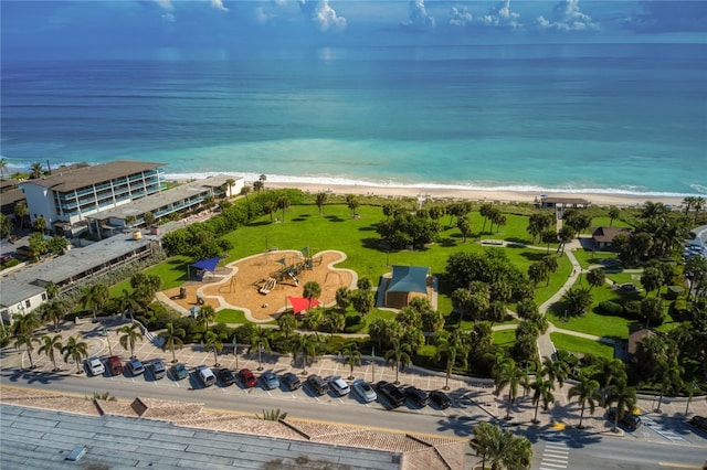 birds eye view of property featuring a view of the beach and a water view