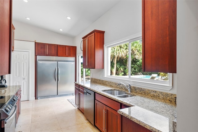 kitchen featuring a wealth of natural light, stainless steel appliances, sink, and vaulted ceiling