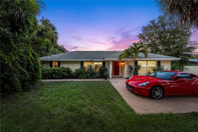 ranch-style house with a lawn