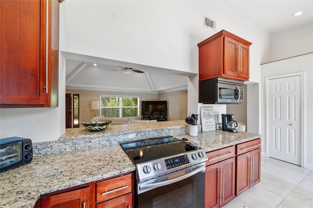 kitchen with light tile patterned floors, ornamental molding, ceiling fan, light stone countertops, and appliances with stainless steel finishes