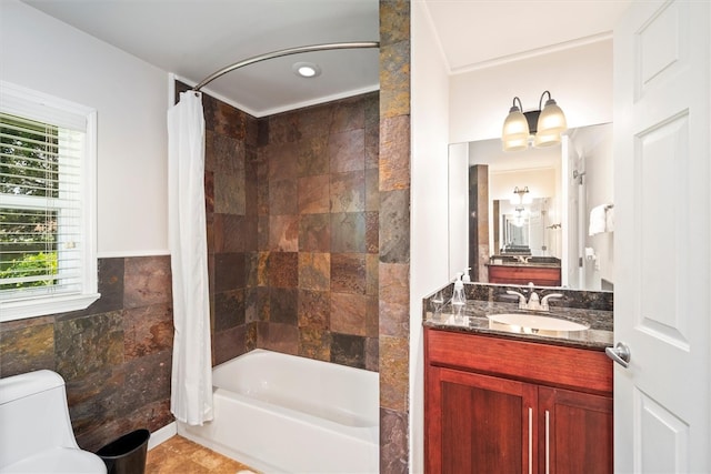 full bathroom with vanity, shower / bath combo, tile walls, and toilet